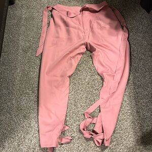 Large pink trousers ties at the ankle